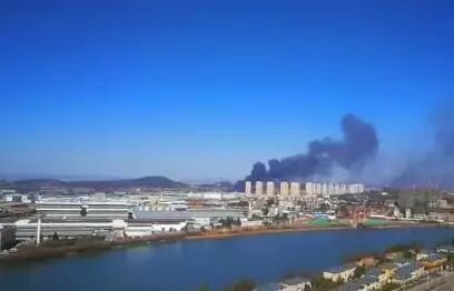 倉(cāng)庫(kù)里往外冒著滾滾黑煙，把周圍的天空染上烏黑色。